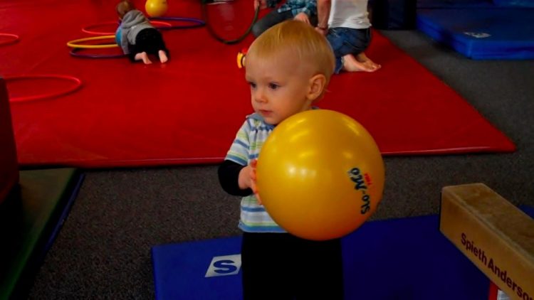 child with ball little gym