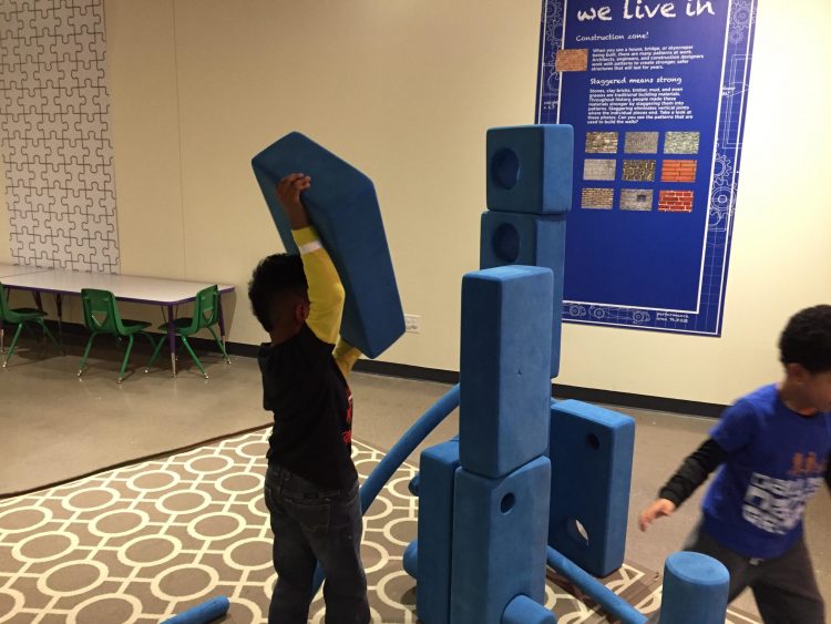 Young kids build a fort with giant foam blocks
