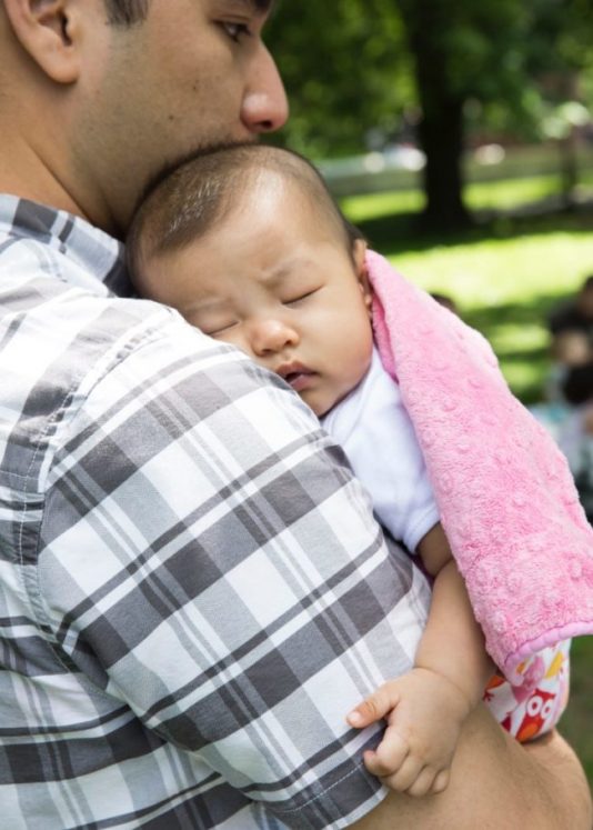 Napping baby on dads cozy shoulder