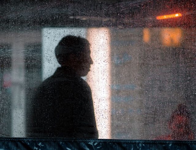 man standing in rain