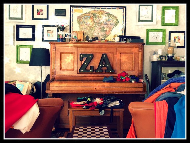 chores laundry piled on chairs and benches in living room