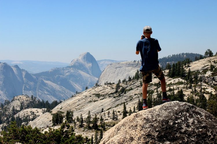 window child taking photos on rocks (photo Whit Honea)
