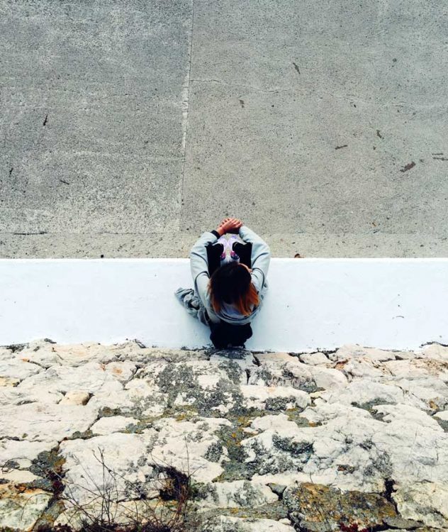 introverted teen girl sits with back to wall introversion introvert